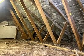 Wooden roof trusses and rafters under construction in an attic or unfinished interior space