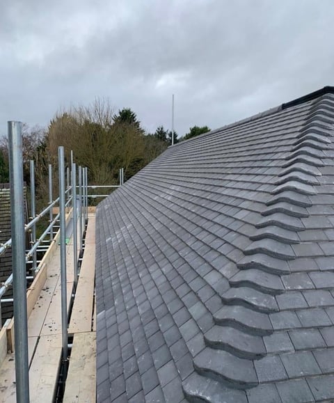 Gray tile roof installation